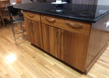 Kitchen cabinet refinishing with a smooth, polished wood finish.