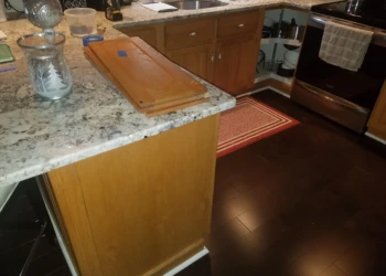 Wooden kitchen cabinets and drawer fronts removed from cabinetry for cabinet refinishing in Pelham NH